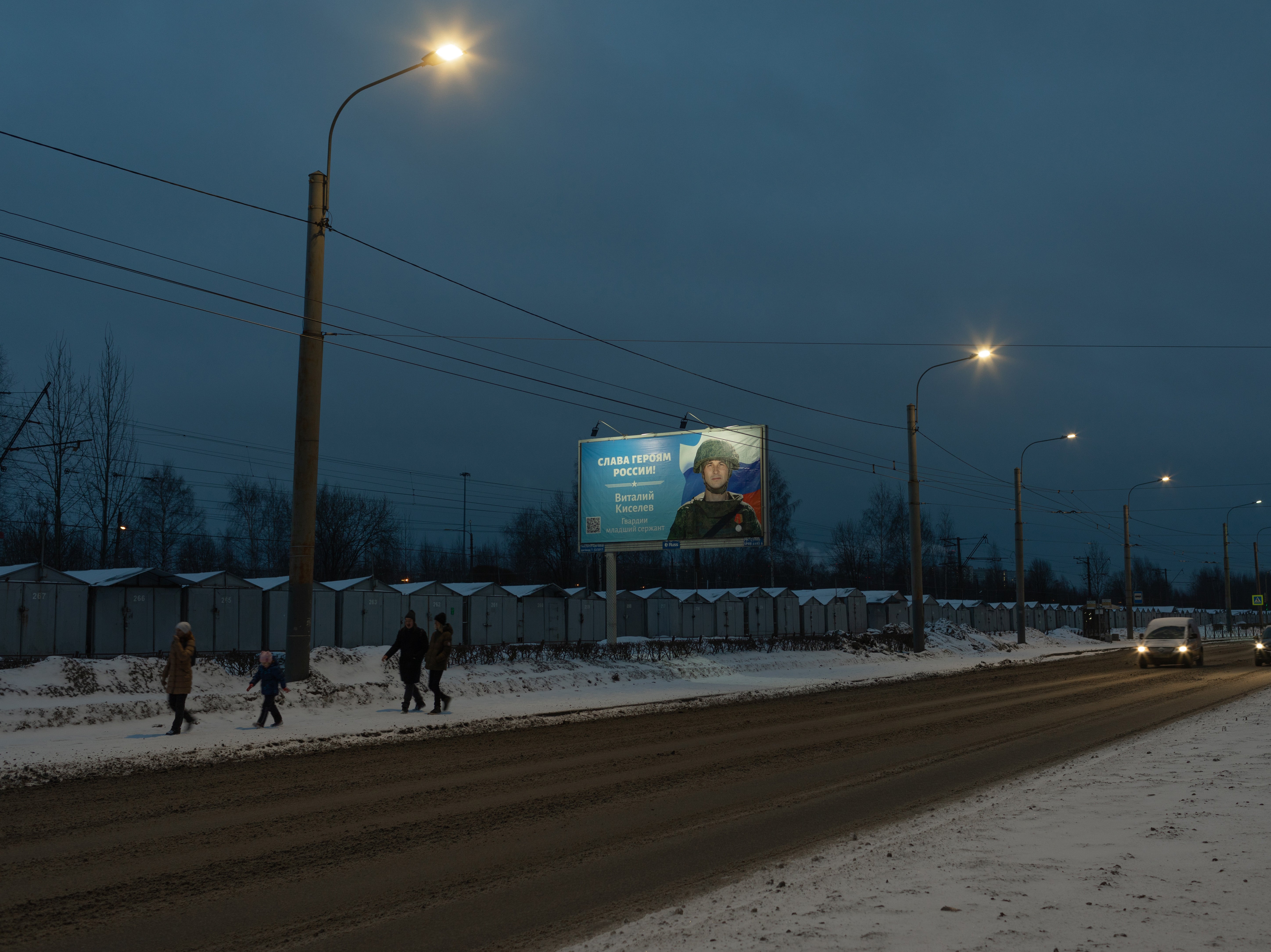 A street in St Petersburg with a billboard that says ‘Glory to the Heroes of Russia’