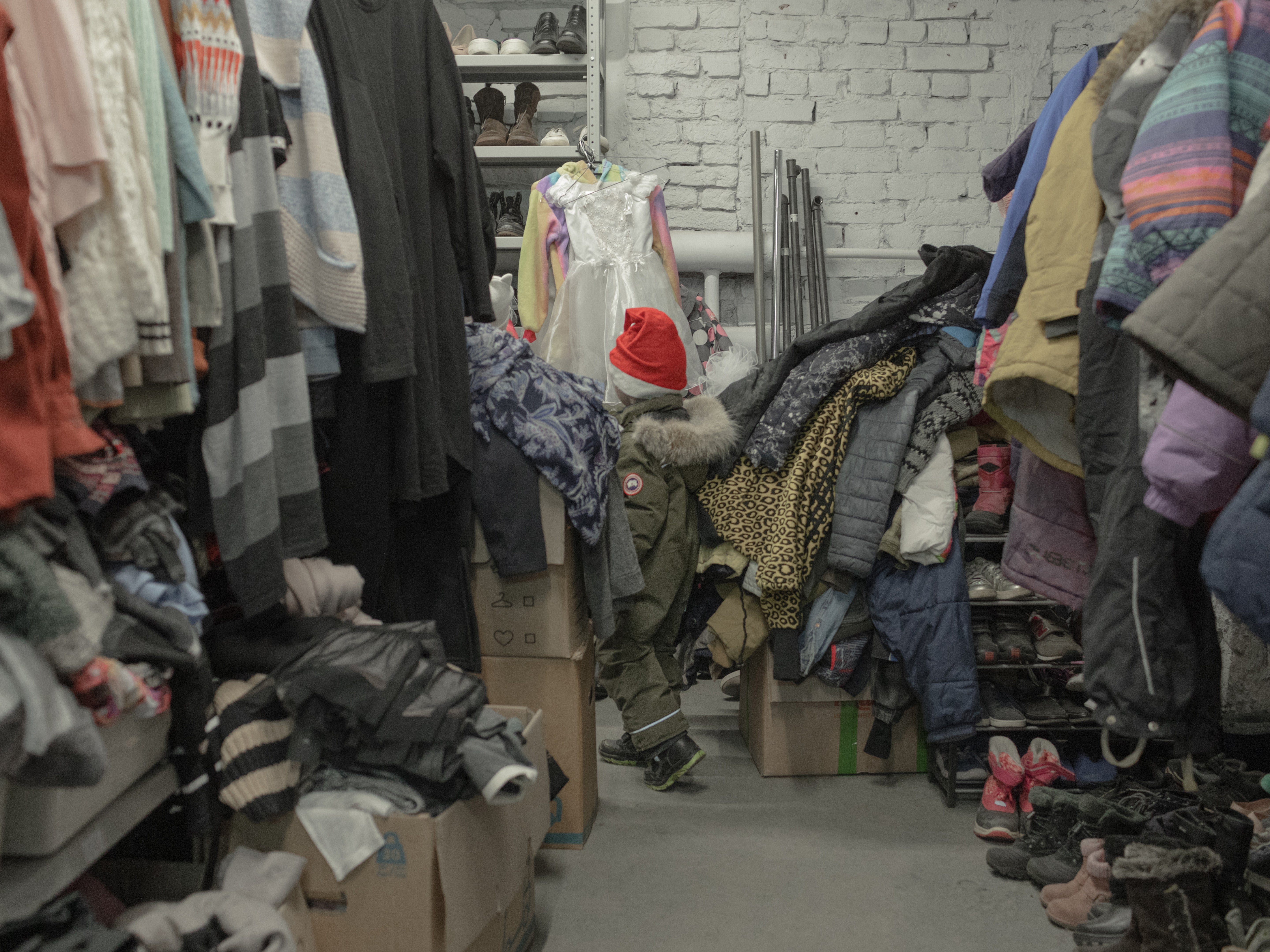 A Ukrainian boy chooses items in Gumsklad, a humanitarian warehouse