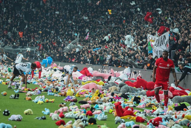 Fans throw toys onto the pitch during Besiktas’ match against Antalyaspor (AP)