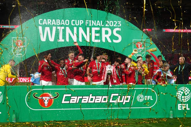 Manchester United lift the trophy (John Walton/PA)