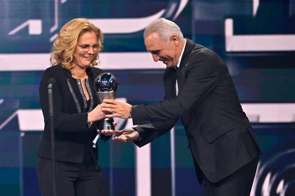 Hristo Stoichkov presents Sarina Wiegman with the female coach of the year award during The Best FIFA Football Awards 2022 in Paris, France