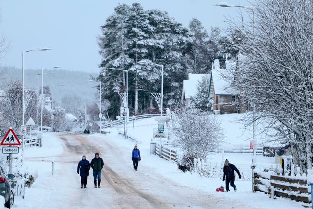 <p>Members of the public make their way through the snow in January in Carrbridge, United Kingdom</p>
