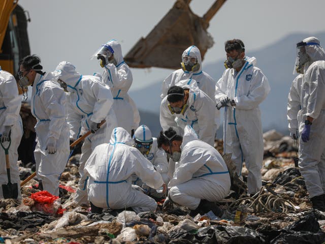 Hong Kong police officers comb through garbage for the remains of murdered model Abby Choi on 28 February 2023