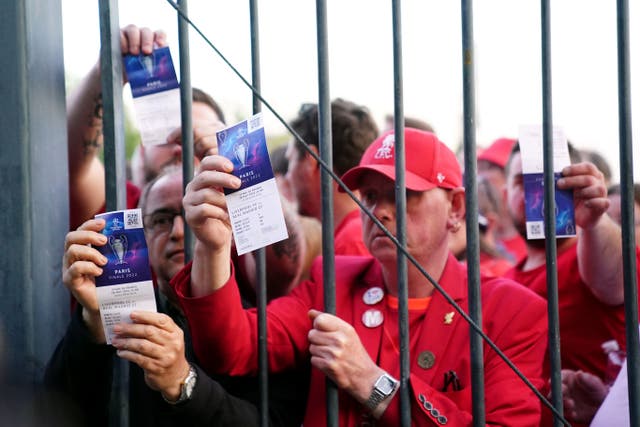 Liverpool fans stuck outside the Stade de France show their match tickets ahead of last season’s Champions League final (Adam Davy/PA)