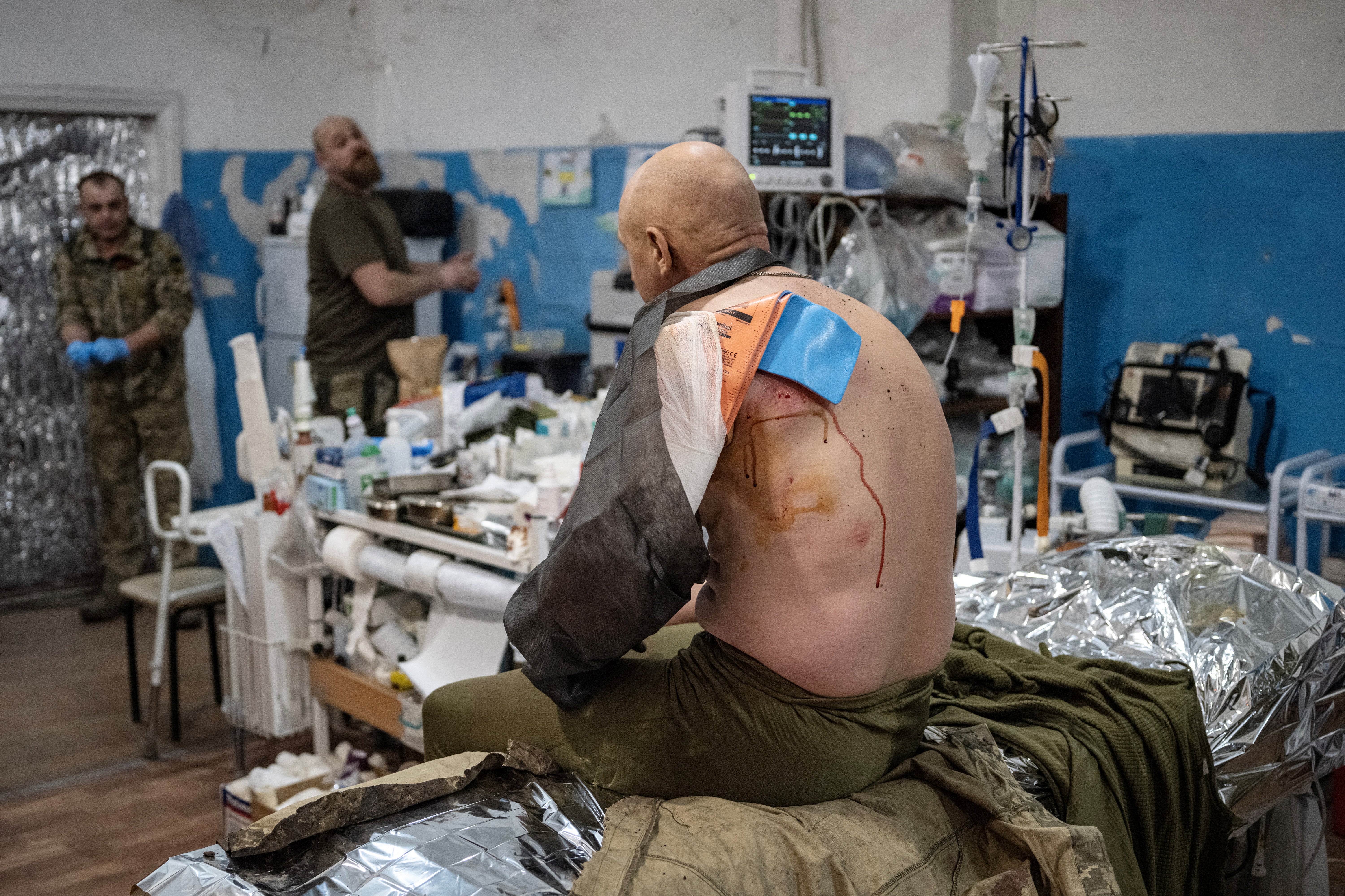 A wounded soldier sits on the operation table