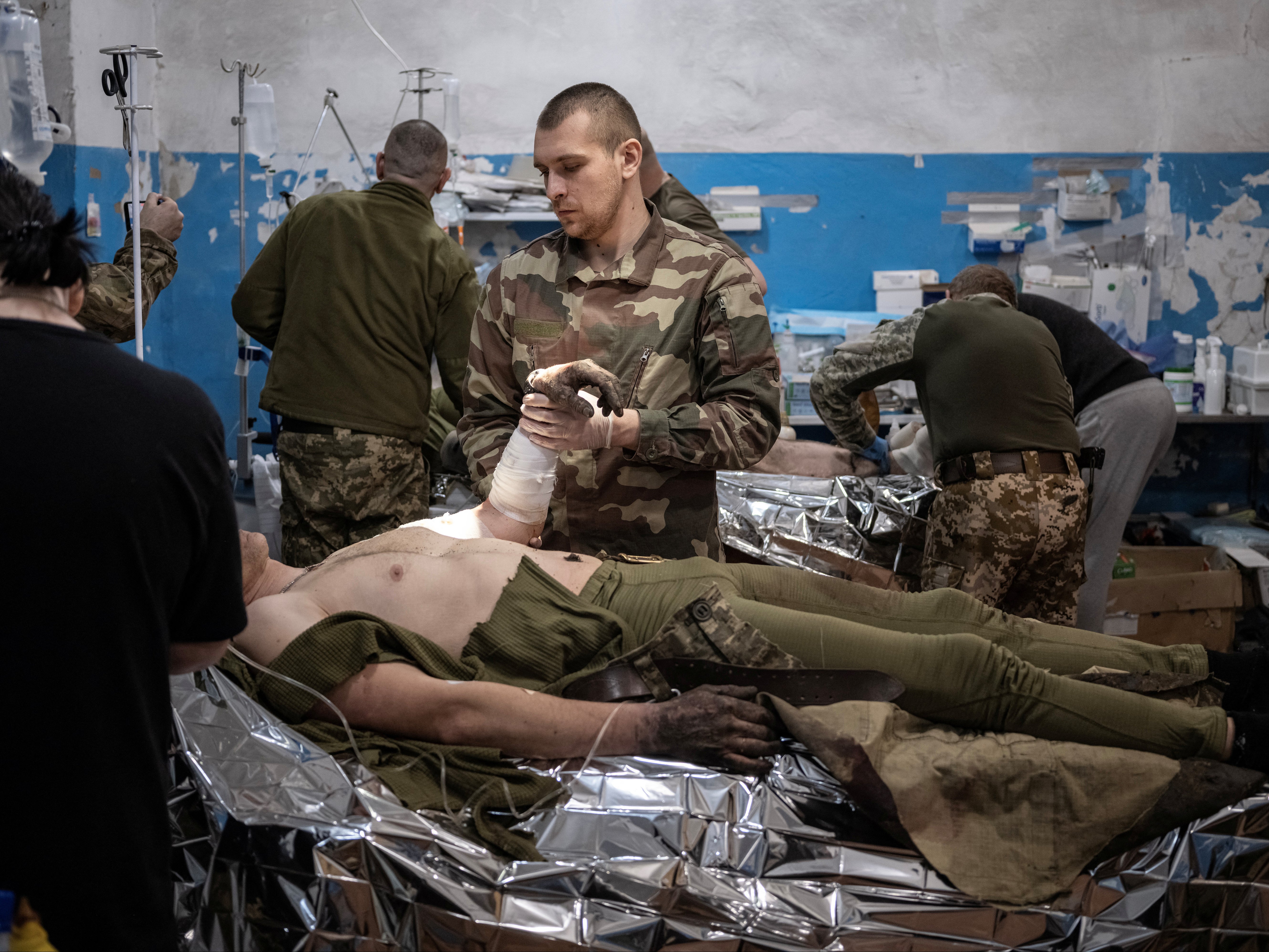 Medics treat wounded Ukrainian soldiers near Vuhledar in the Donetsk region