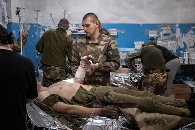 <p>Medics treat wounded Ukrainian soldiers near Vuhledar in the Donetsk region</p>