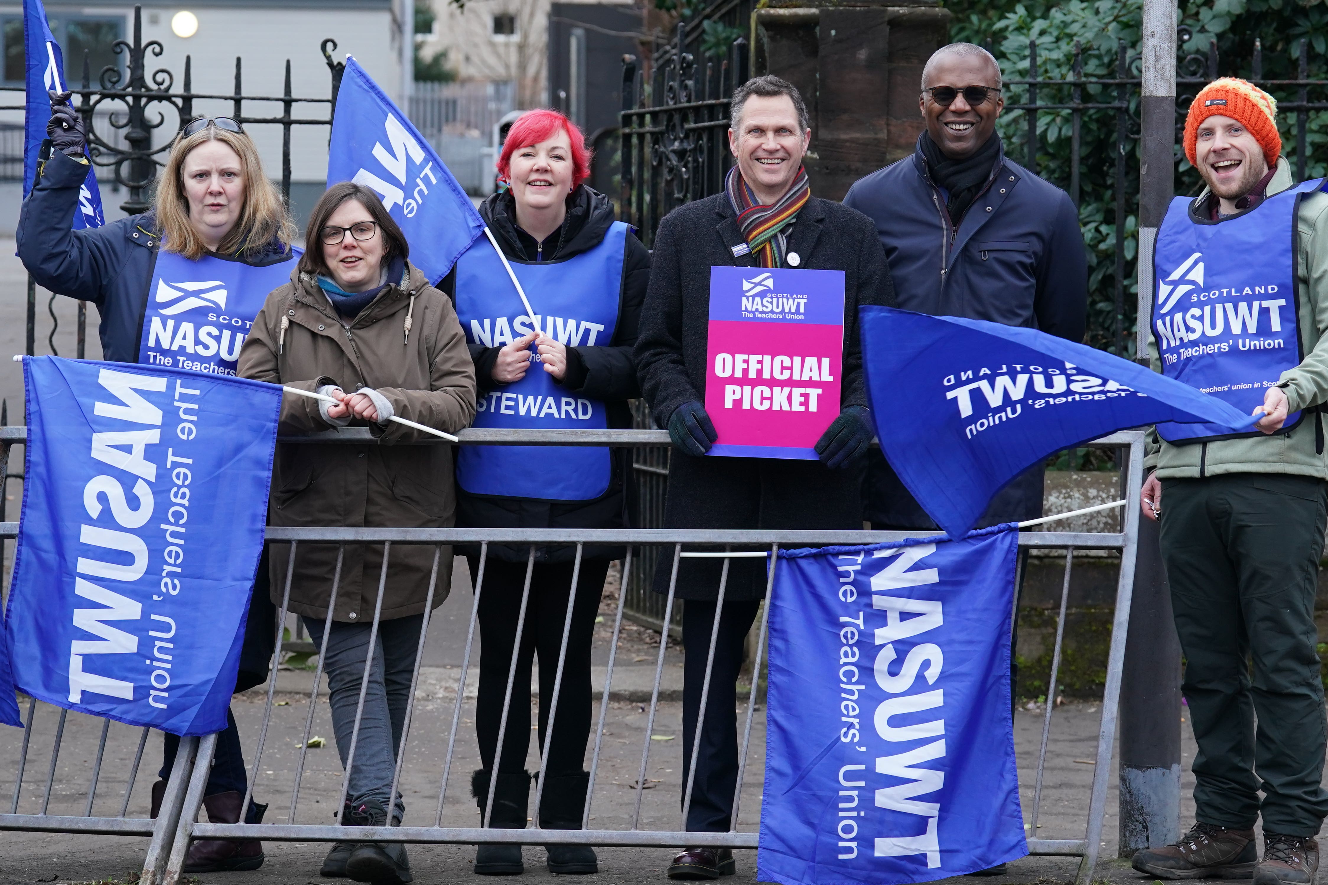 Officials of NASUWT and teachers on strike (Andrew Milligan/PA)