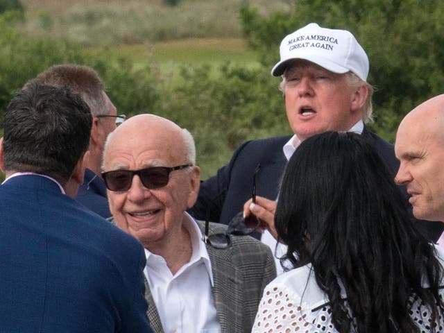 <p>Donald Trump with Rupert Murdochafter a tour of his International Golf Links course north of Aberdeen on the east coast of Scotland on June 25, 2016</p>
