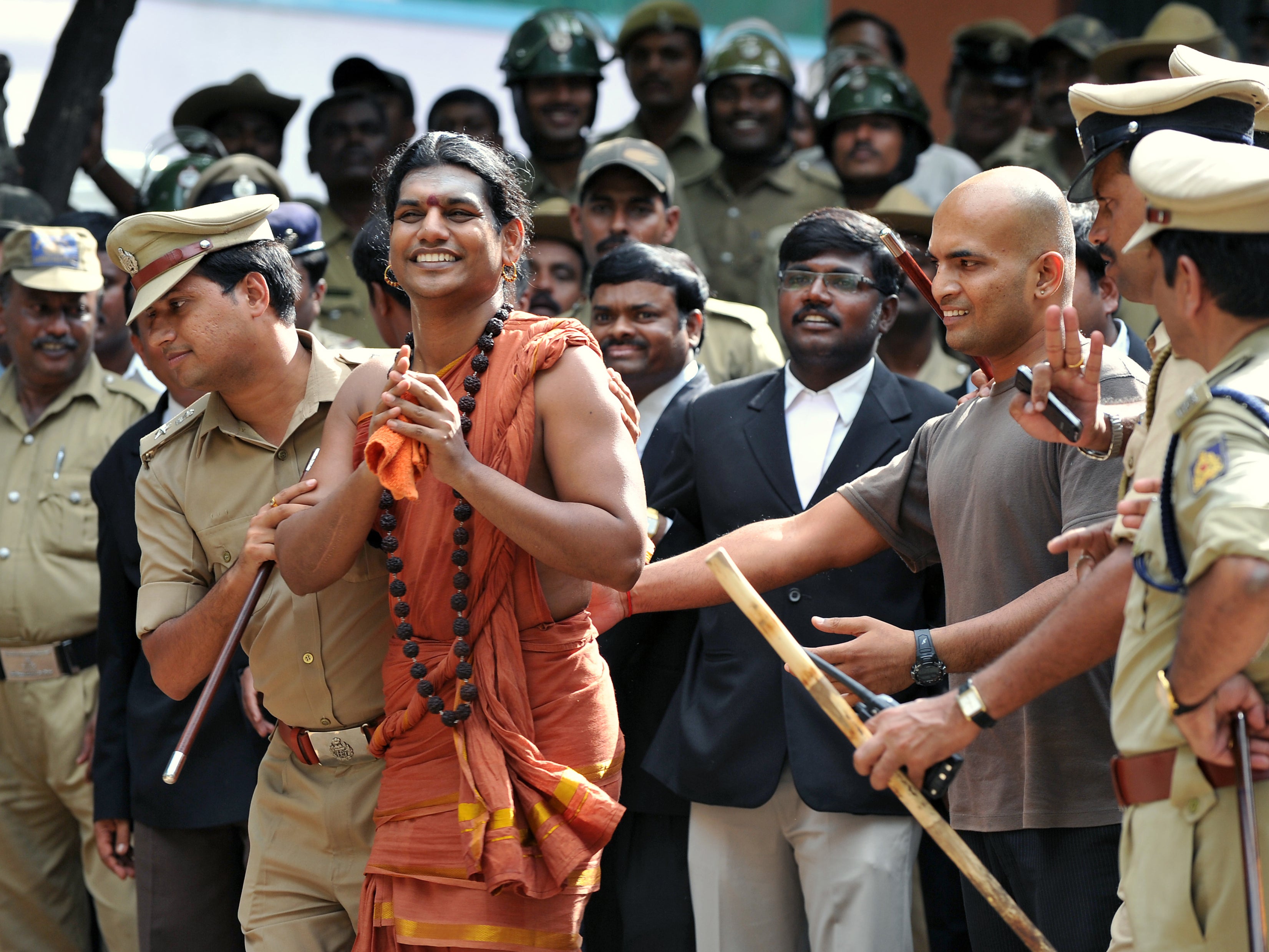 <p>File. Police escort controversial Hindu Godman Swami Nityananda (2nd L) after appearing for his bail plea at the judicial magistrate court at Ramanagar District, some 50 kms from Bangalore, India on 14 June 2012</p>