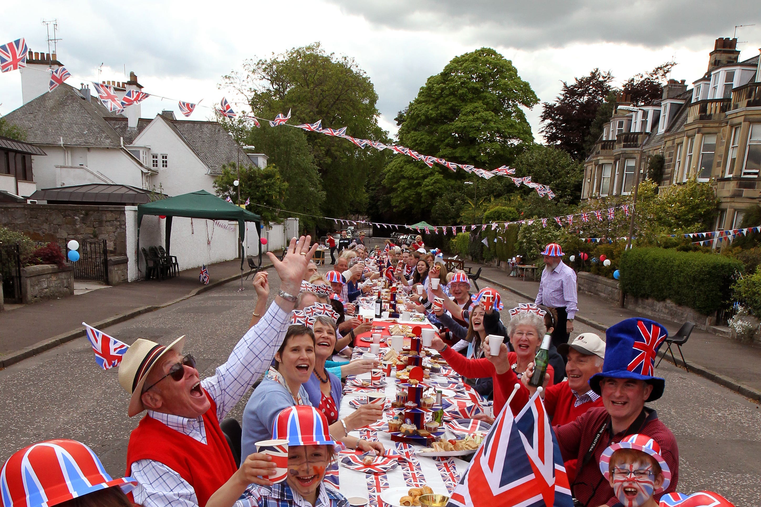 Residents of Murrayfield Drive in Edinburgh sit down to a Jubilee street party in 2012 (Andrew Milligan/PA)