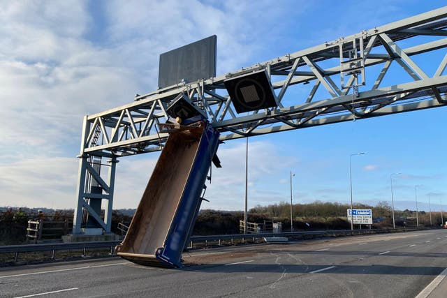 <p>The tipper truck became wedged under an overhead gantry on the M5 near Bristol </p>