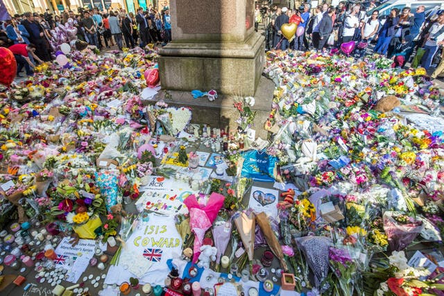 Floral tributes in St Ann’s Square, close to the Manchester Arena (Danny Lawson/PA)