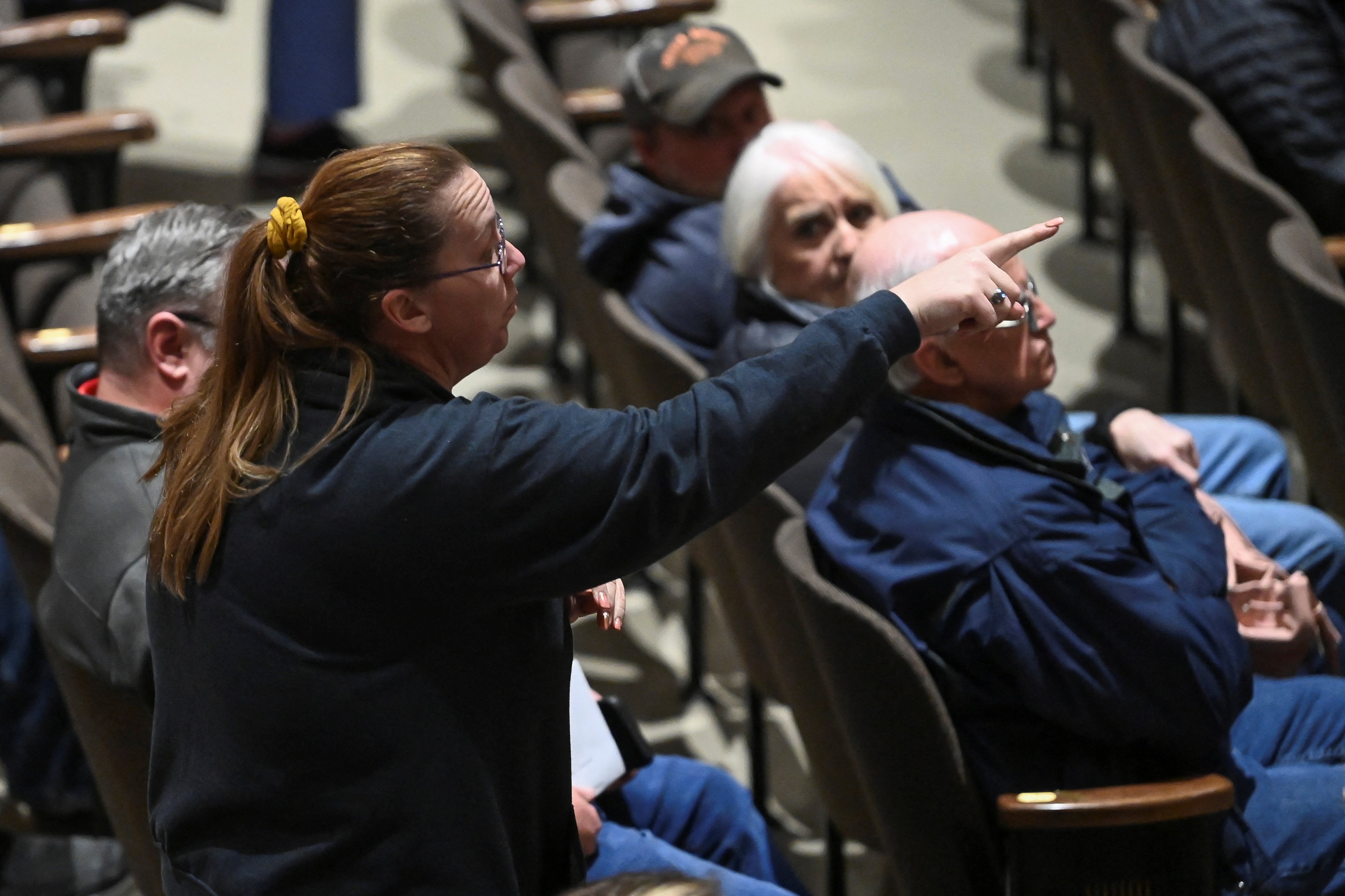 A woman points her finger during the town hall held in East Palestine on Thursday