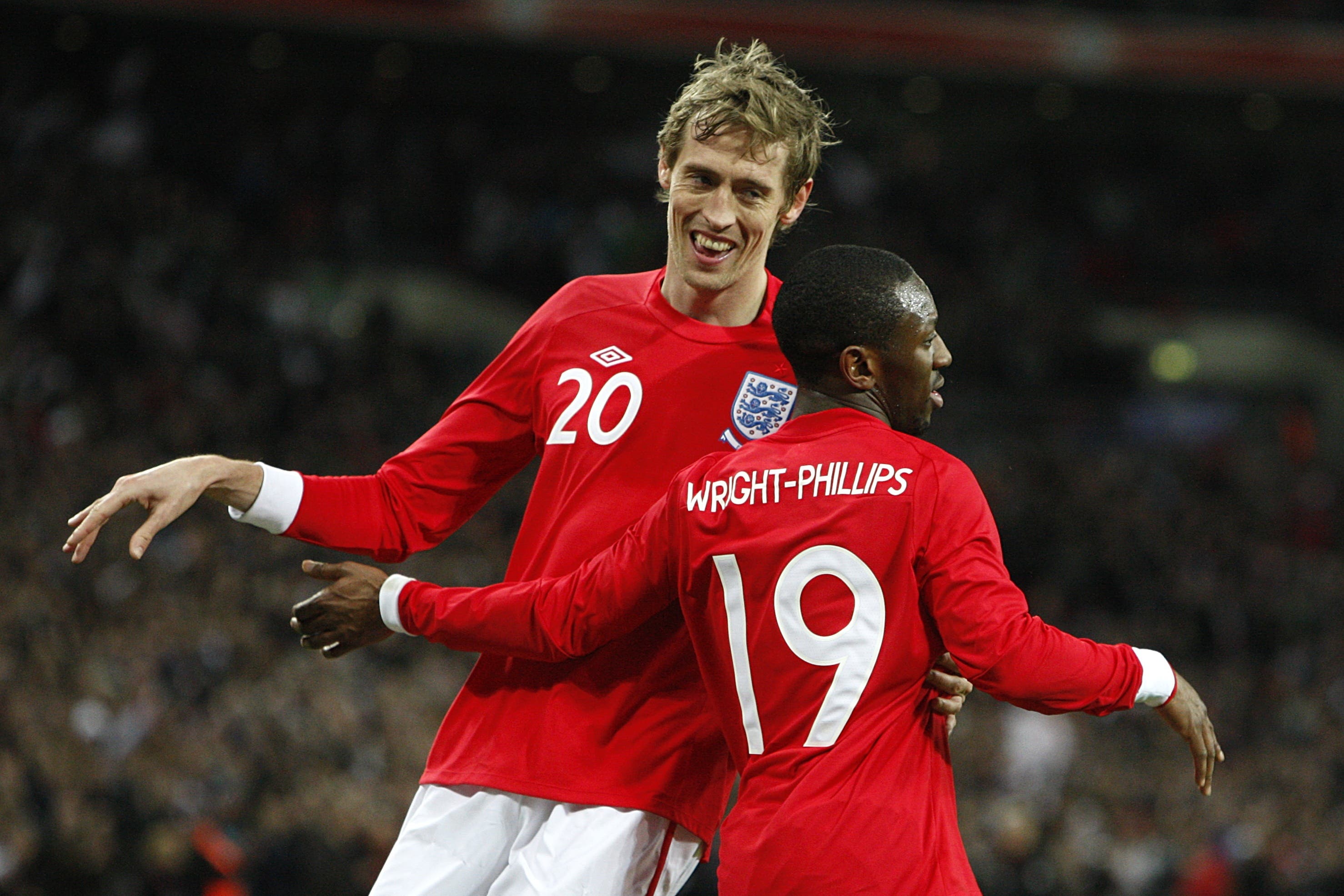 England’s Peter Crouch, left, celebrates scoring (Sean Dempsey/PA)