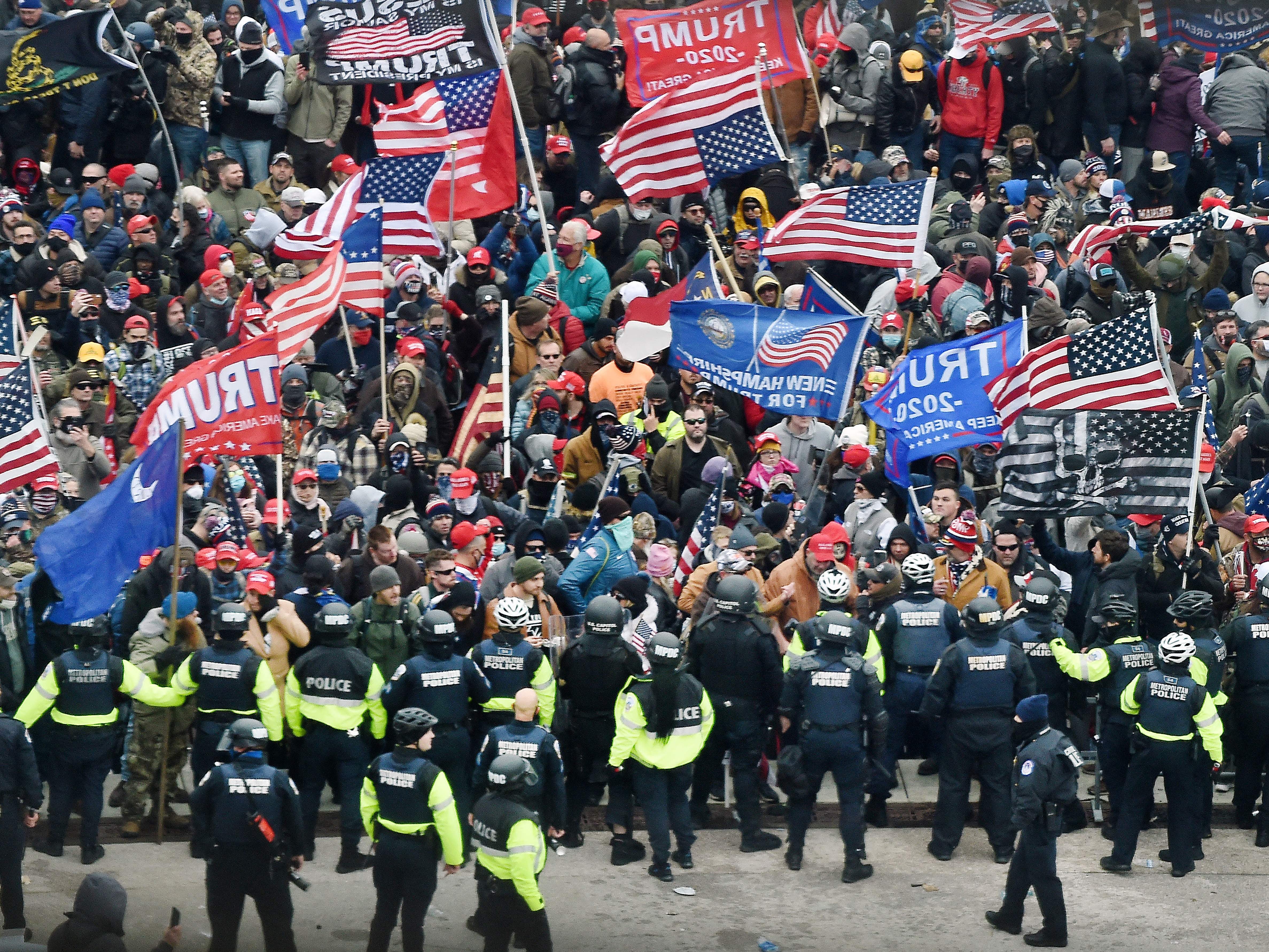 Trump supporters clash with police and security forces as they storm the US Capitol in Washington, DC on January 6, 2021