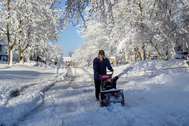 <p>Ross Weaver plows out a section of road in front of his home in Farmington Hills, Michigan, on Saturday after a winter storm left several inches of snow across the Metro Detroit area.</p>