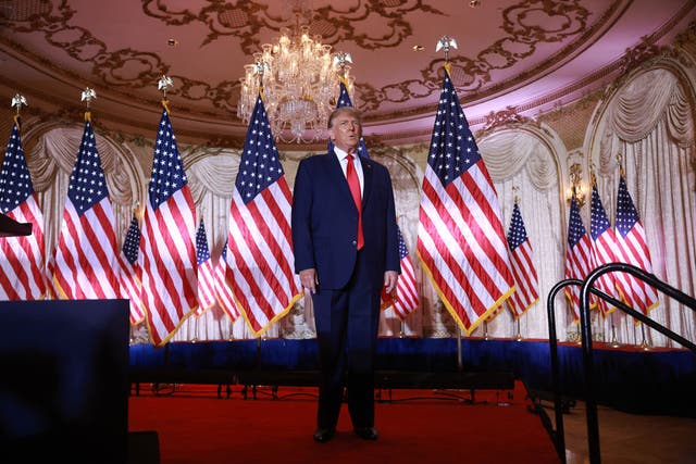 <p>Donald Trump speaks at Mar-a-Lago amid a presidential-looking backdrop of American flags</p>