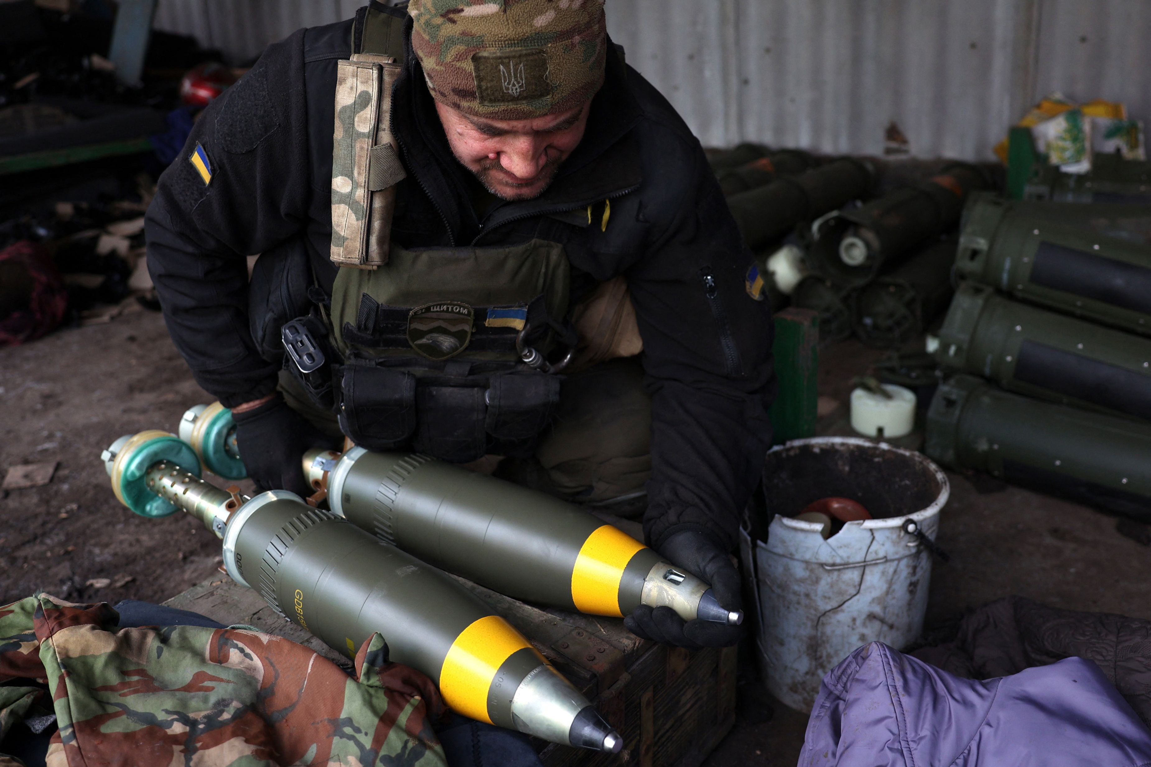 A Ukrainian soldier prepares 120 mm mortars at a front line in the Donetsk region