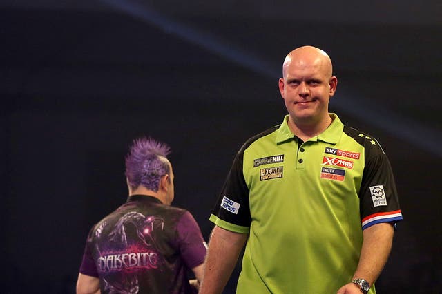 Michael van Gerwen, right, is through to the quarter-finals of the UK Open but Peter Wright, left, is out (PA)
