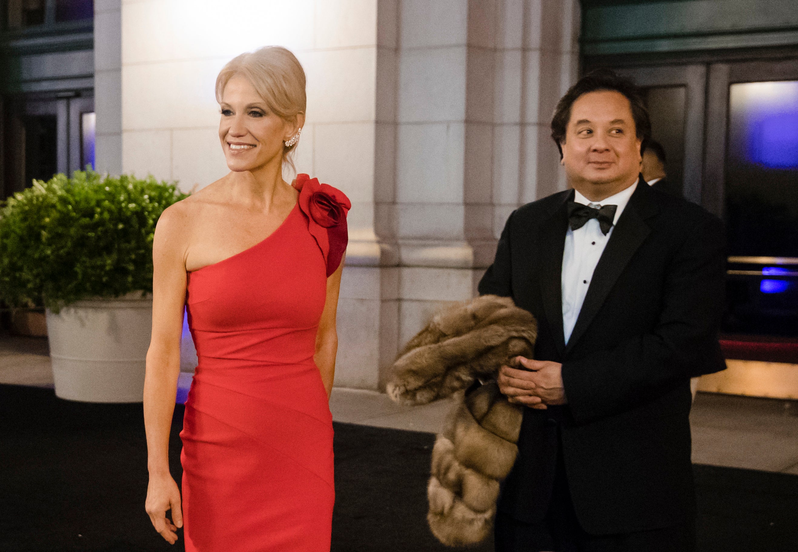 Kellyanne and George Conway speaks with members of the media at a dinner one day before Trump's inauguration in January 2017