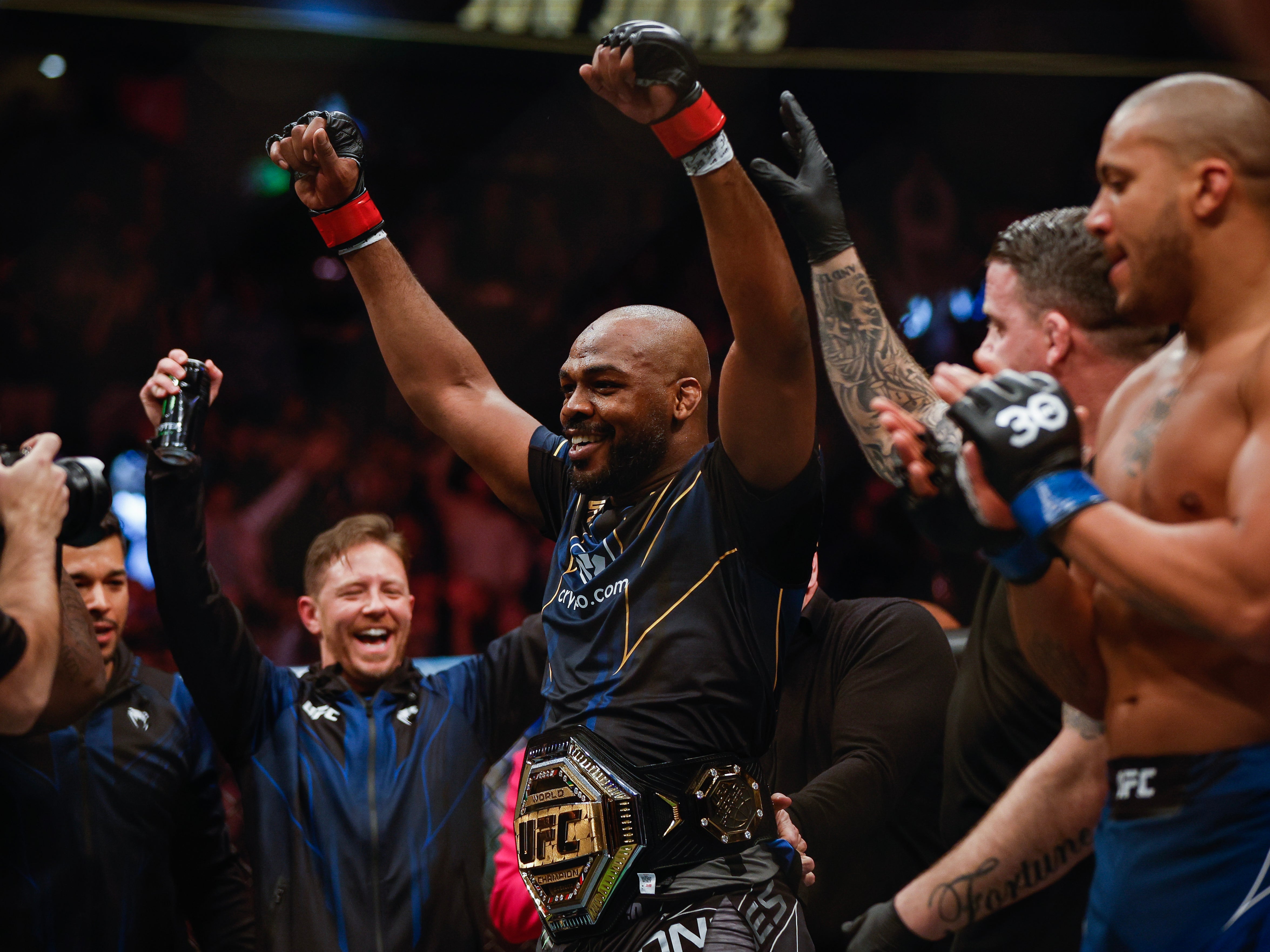 Jones celebrates becoming a two-division UFC champion