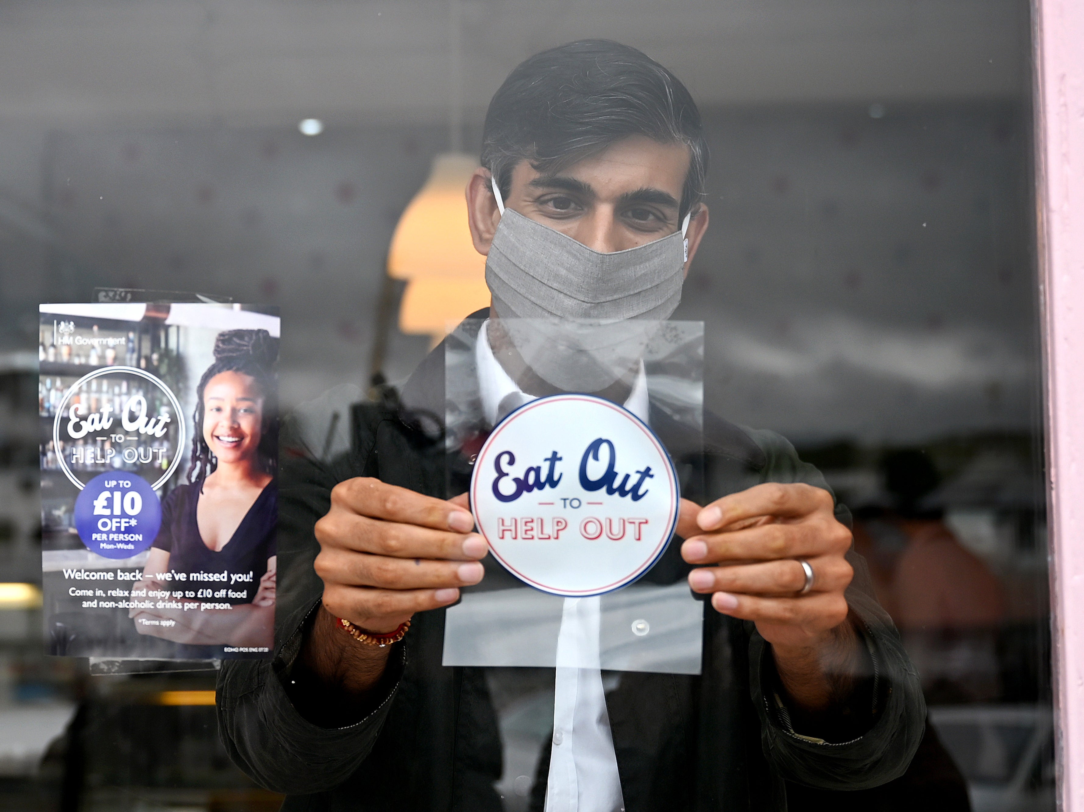 Rishi Sunak places Eat Out to Help Out sticker in window