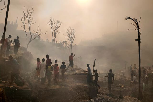 <p>Rohingya refugees try to salvage their belongings after a major fire in their camp in Cox’s Bazar</p>