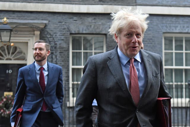 <p>Boris Johnson, accompanied by Cabinet Secretary Simon Case (left)</p>