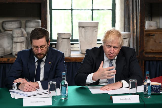 <p>Then-prime minister Boris Johnson (right) and Cabinet Secretary Simon Case (Oli Scarff/PA)</p>