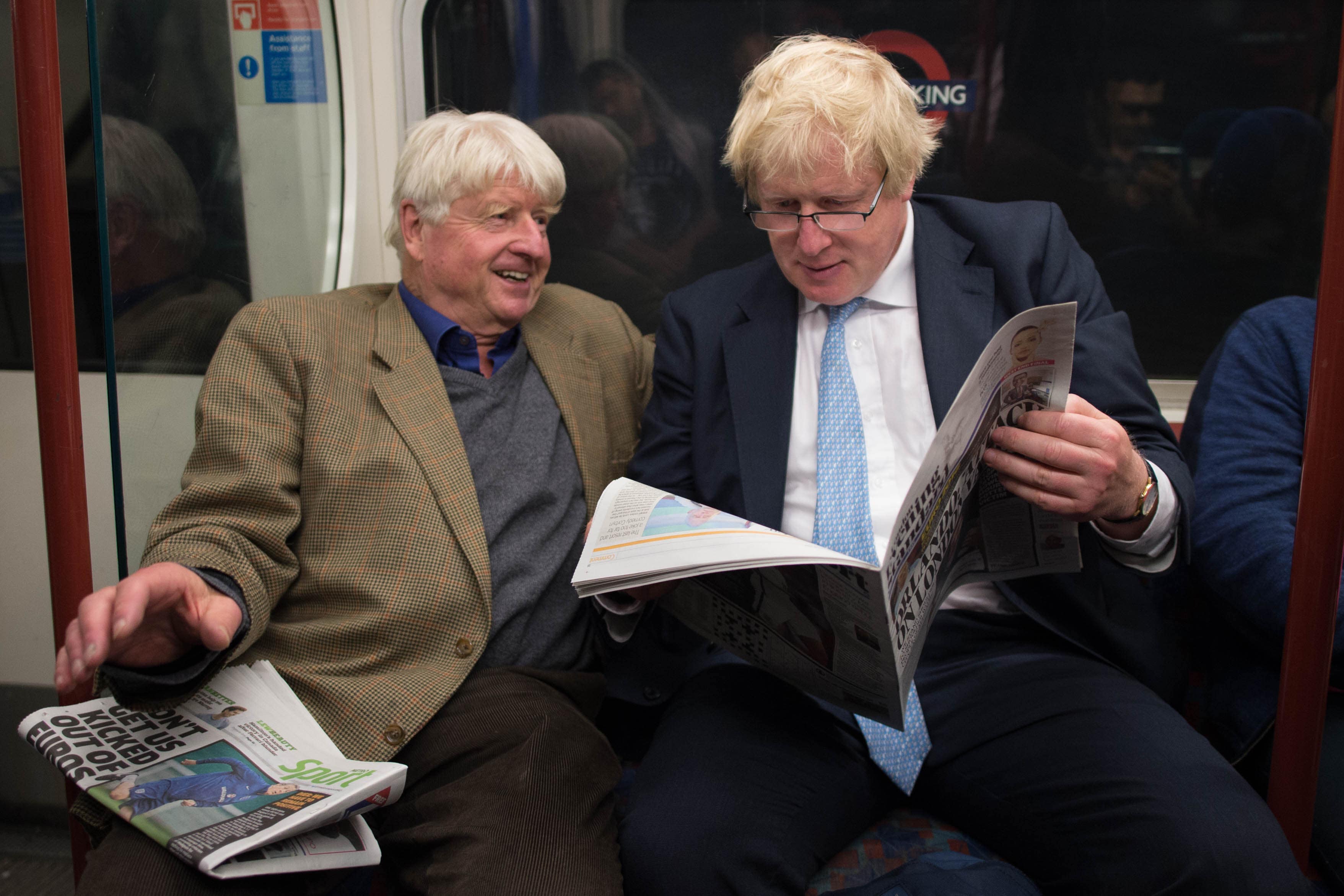 Boris Johnson sits next to his father Stanley on the Bakerloo Line in London