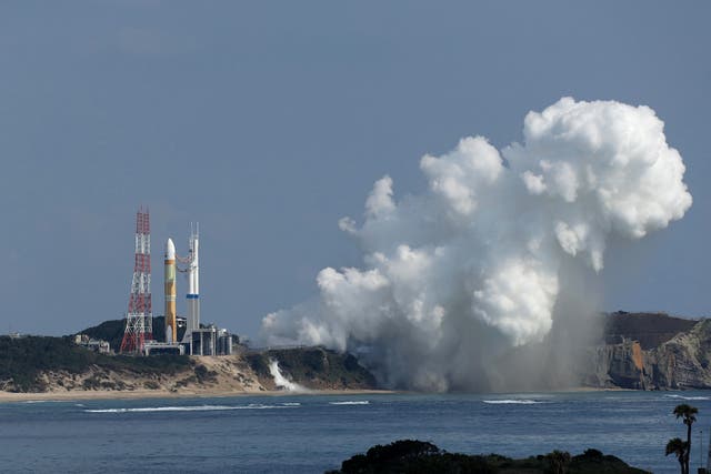 <p>White smoke emerges from the main engines of the next-generation H3 rocket (L) as it fails to lift off the launch pad at the Tanegashima Space Center in southwestern Japan on February 17, 2023.</p>