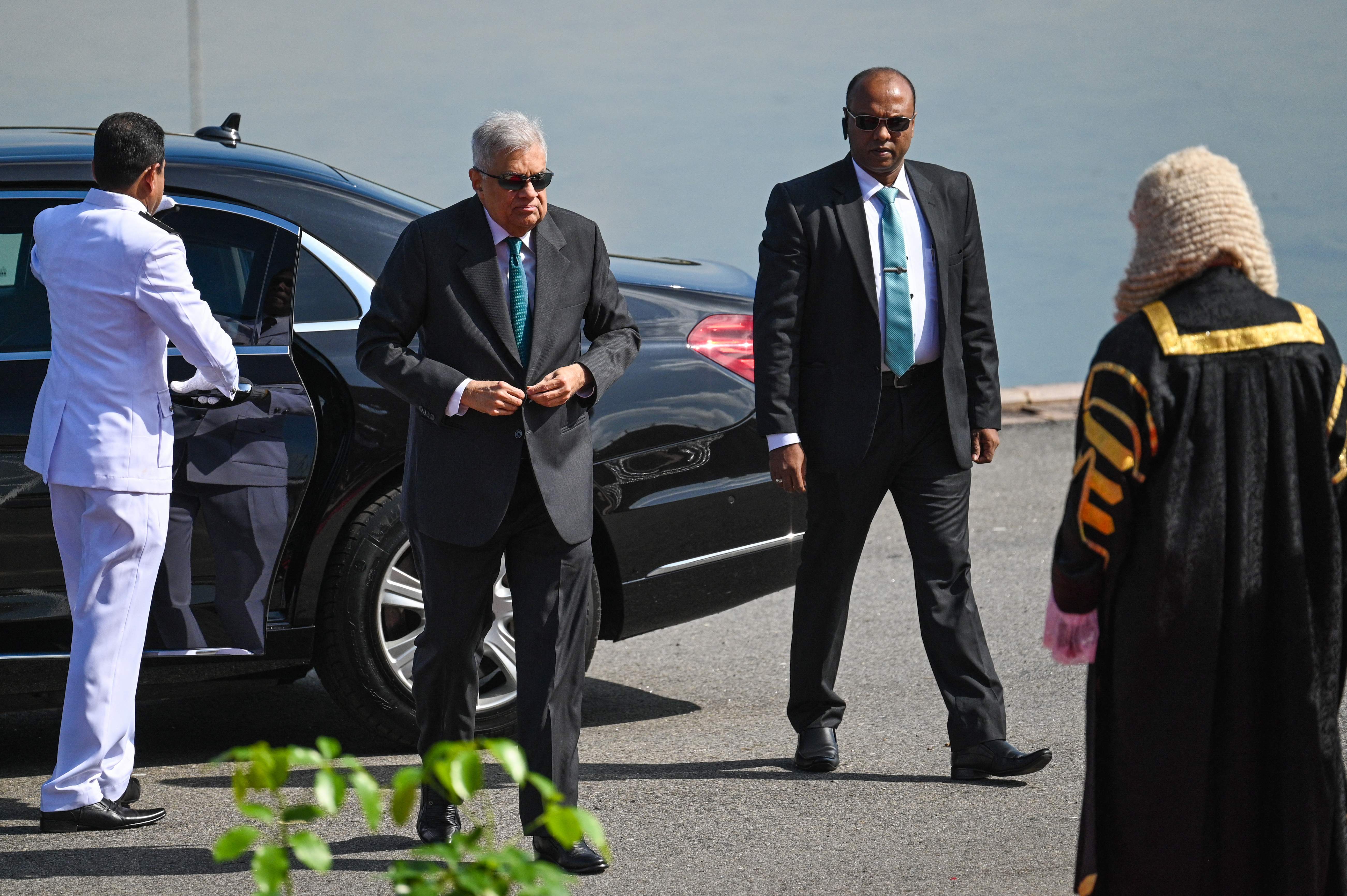 File Sri Lanka's President Ranil Wickremesinghe (2L) arrives for the opening session of the parliament in Colombo