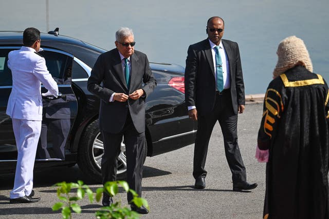 <p>File Sri Lanka's President Ranil Wickremesinghe (2L) arrives for the opening session of the parliament in Colombo</p>
