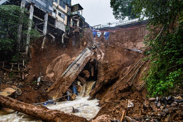 <p>The foundation of a building on the edge of the ravine is seen following a landslide caused from heavy rains in the Caringin area, in Bogor on 2 March 2023</p>