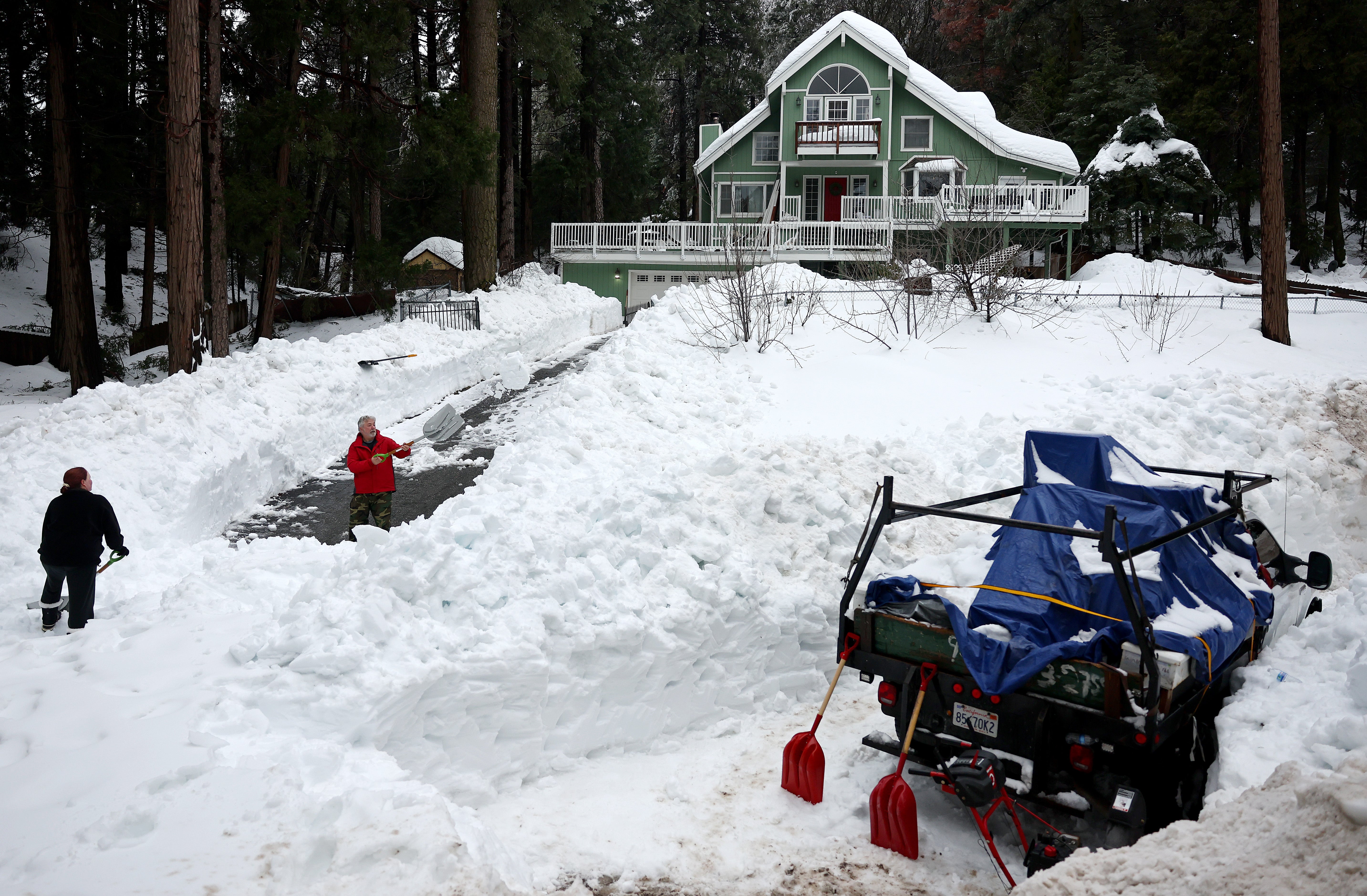 Residents attempt to shovel out their driveway in Crestline this week