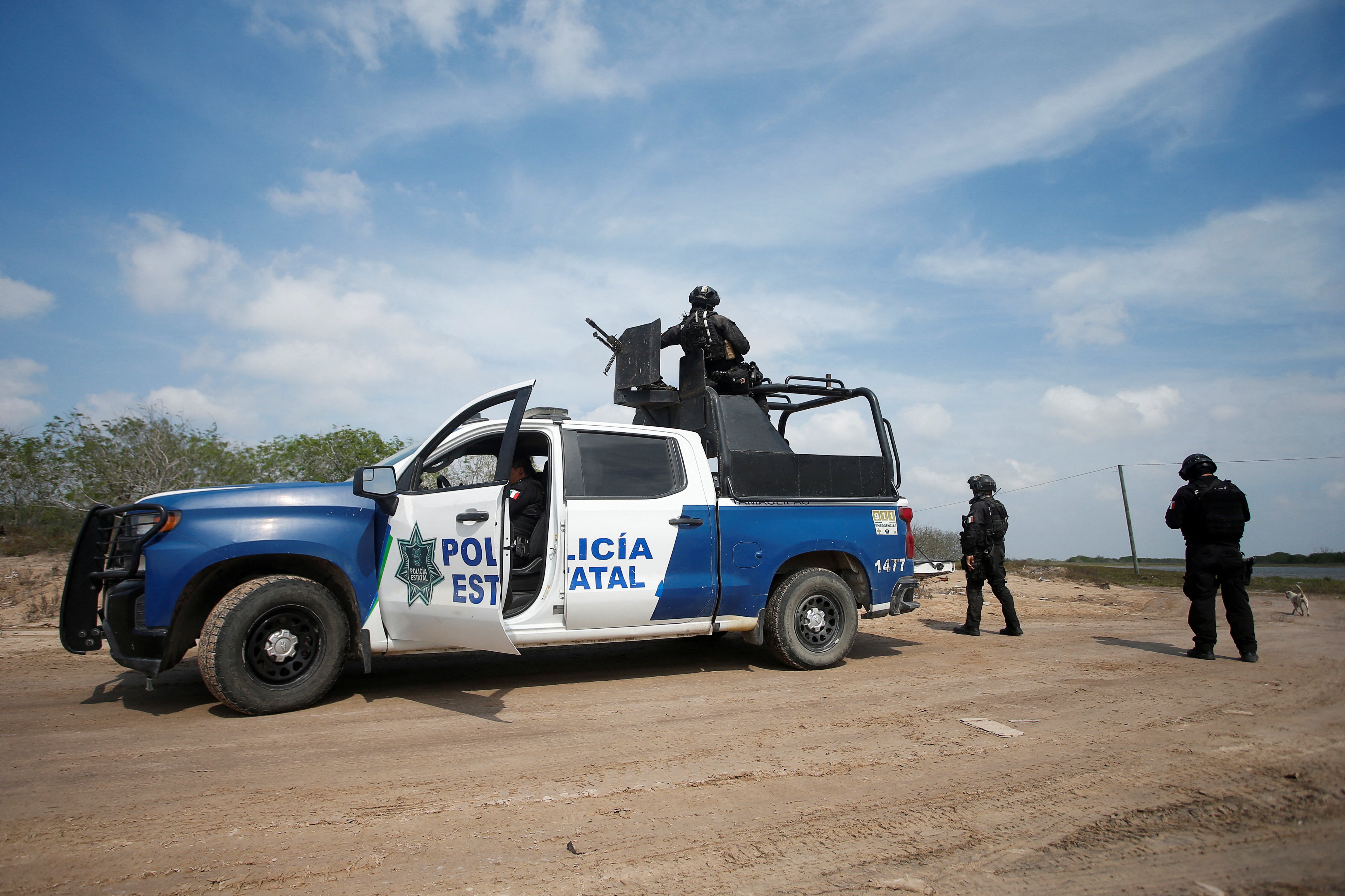 State police officers keep watch at the scene where authorities found the bodies of two of four Americans kidnapped by gunmen, in Matamoros, Mexico, March 7, 2023