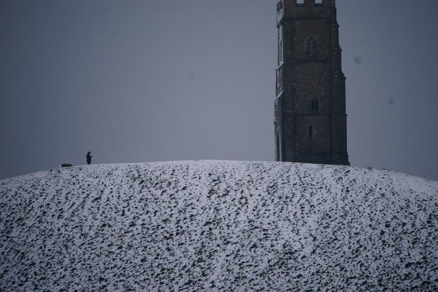 <p>Snow settles on Glastonbury Tor after the UK’s coldest night of the year</p>