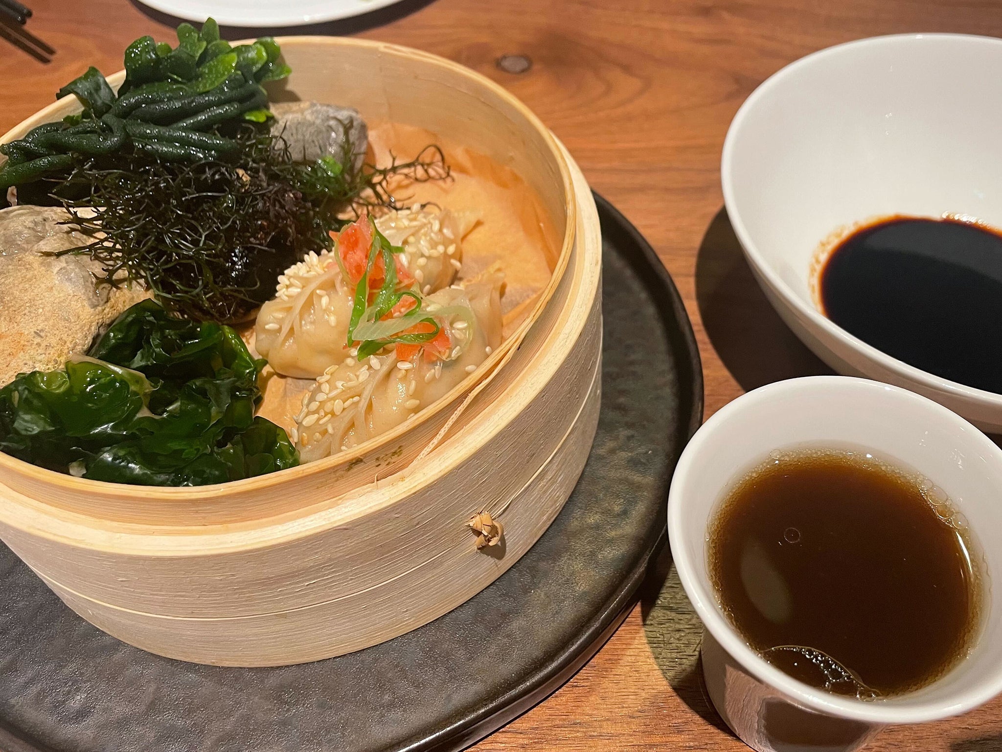 Crab dumplings are served with steamed seaweed for the aroma