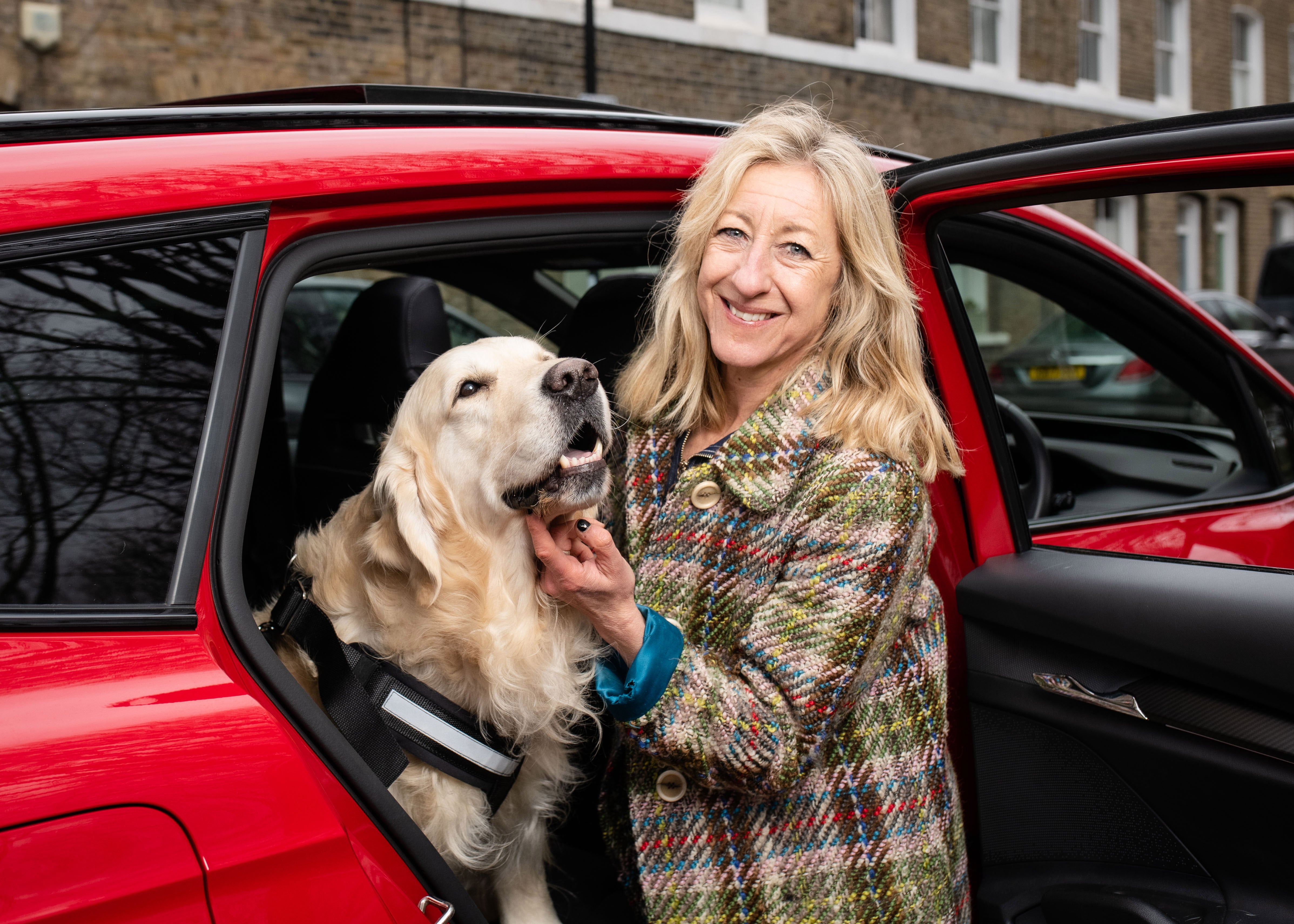 Dog behaviourist Anna Webb with happy Labrador Boris who is relaxed after enjoying the playlist