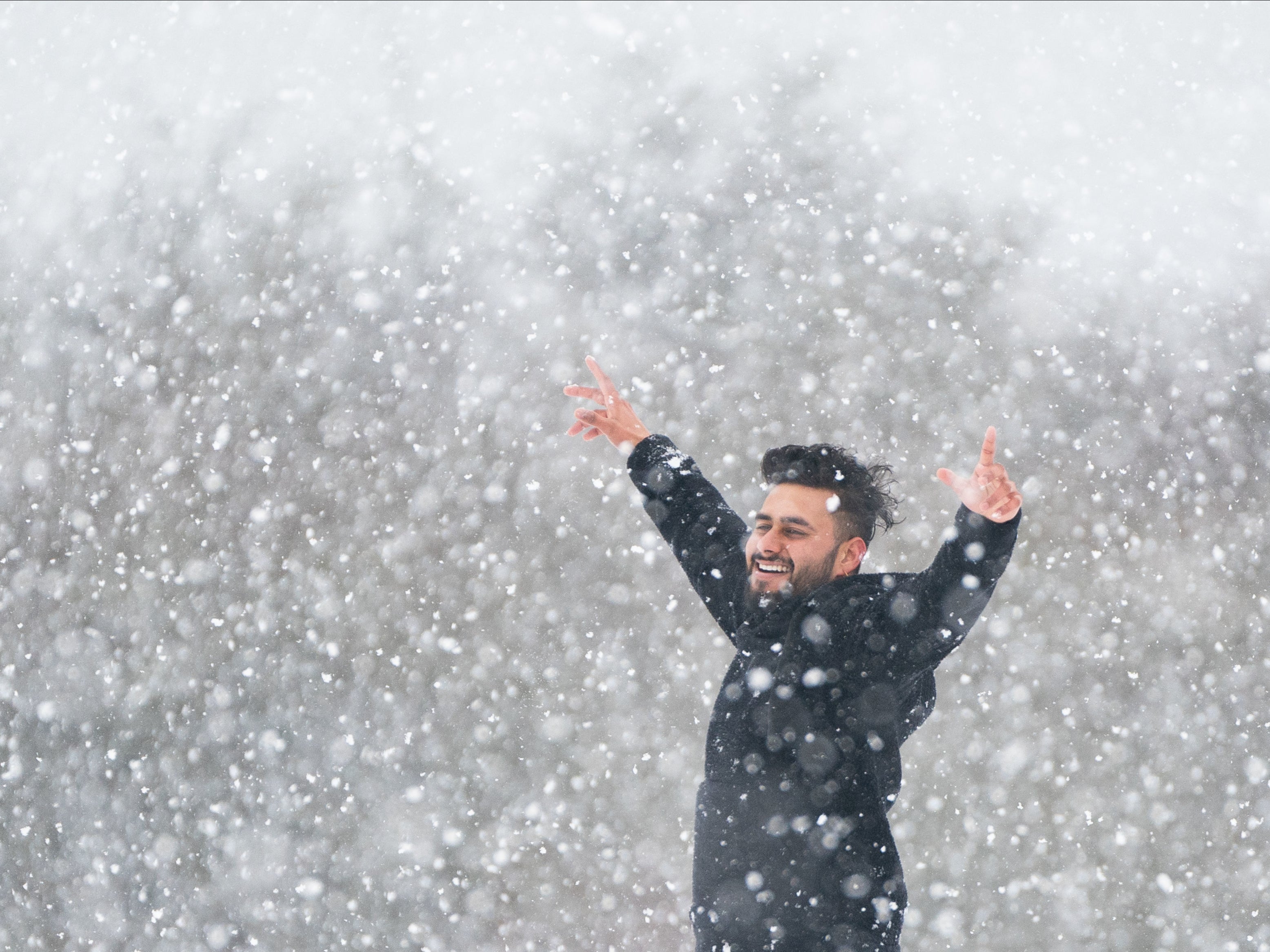 A man enjoys the snow on the Dunstable Downs in Bedfordshire