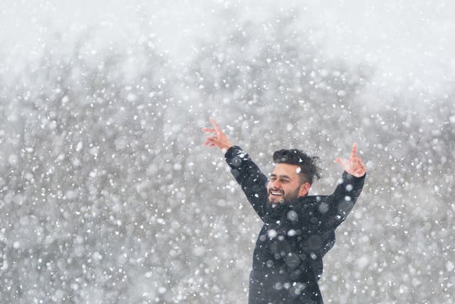 <p>A man enjoys the snow on the Dunstable Downs in Bedfordshire</p>