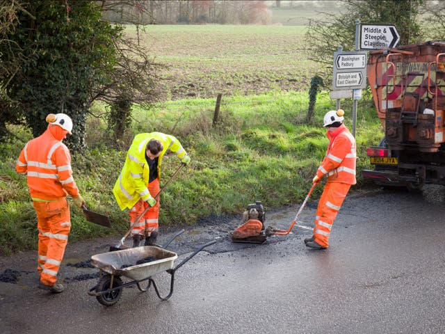 A road works team repairs a pothole in Buckingham