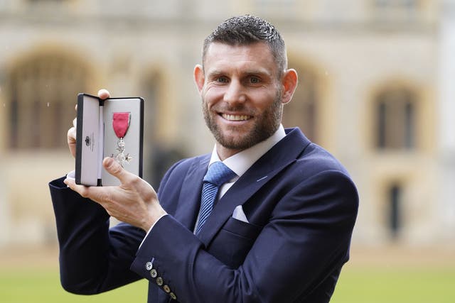 James Milner received an MBE from the Prince of Wales during an investiture ceremony at Windsor Castle (PA)