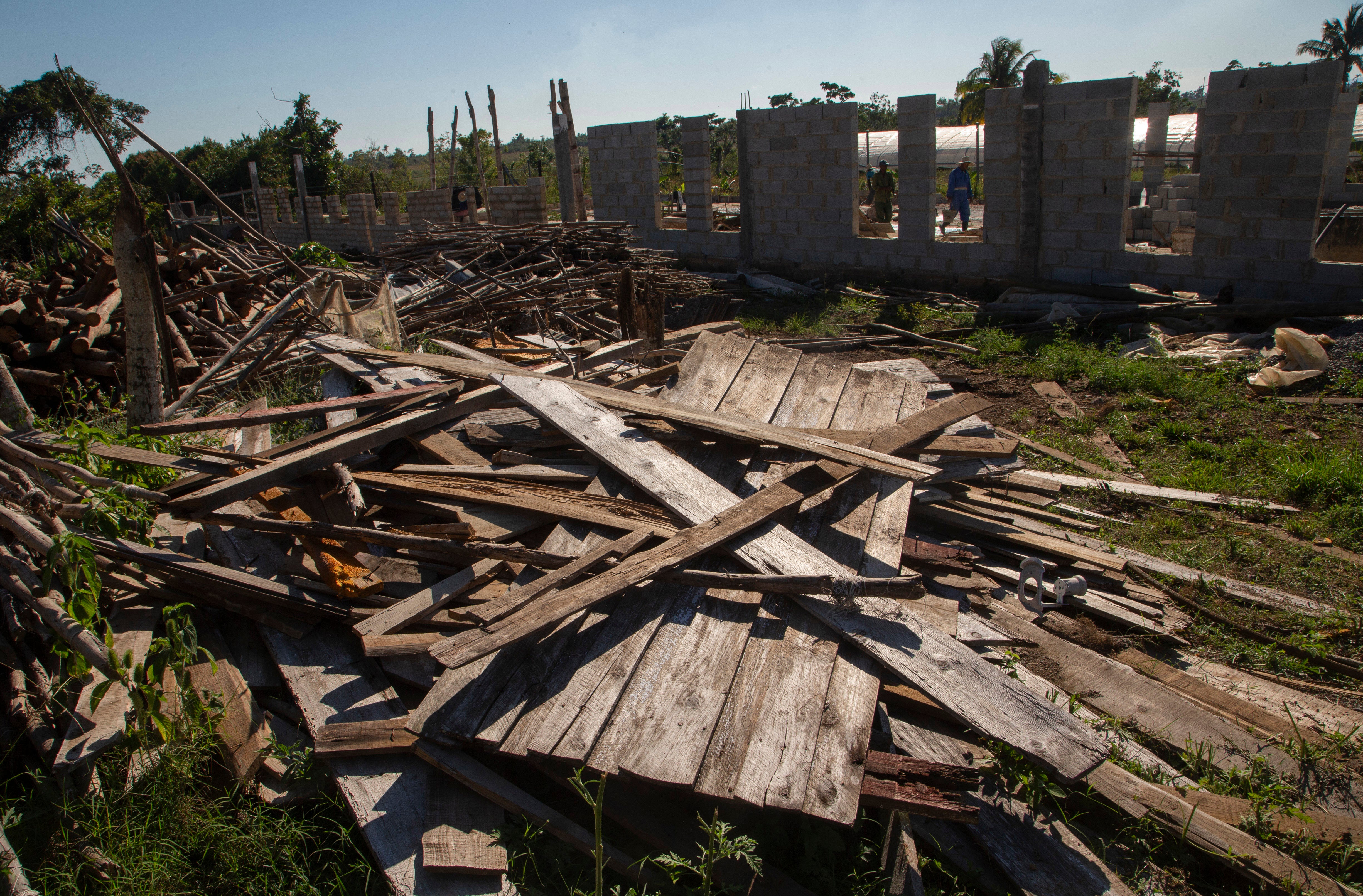 Workers construct a new tobacco house, as they recover from the destruction caused by 2022's Hurrican Ian in Pinar del Río, Cuba