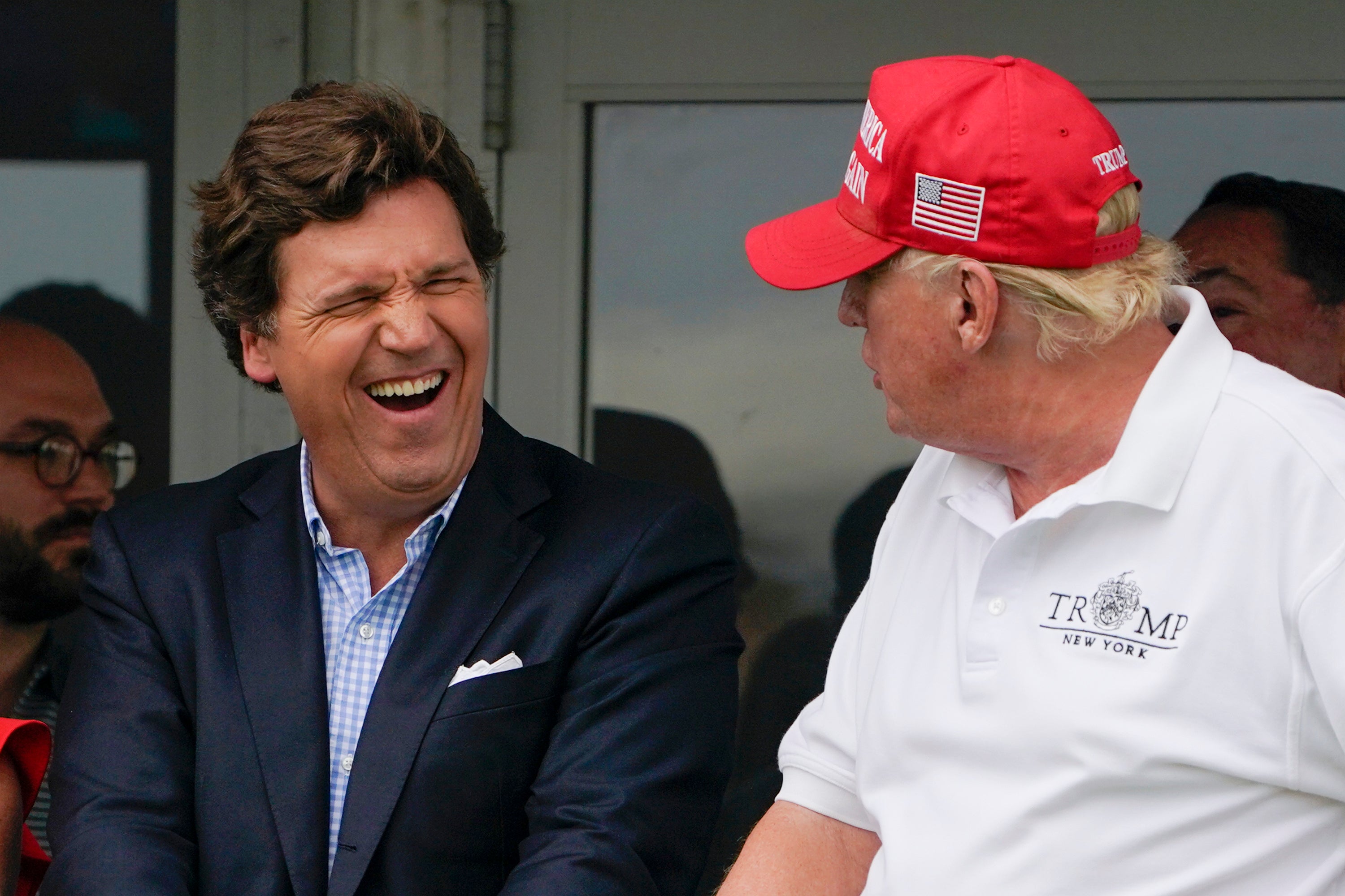 Tucker Carlson, left, and former President Donald Trump at the Bedminster Invitational LIV Golf tournament in Bedminster, New Jersey, on July 31, 2022