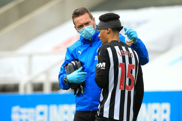 Newcastle’s Jamal Lewis receives treatment for a head injury during a Premier League match in 2020 (Lindsey Parnaby/PA)