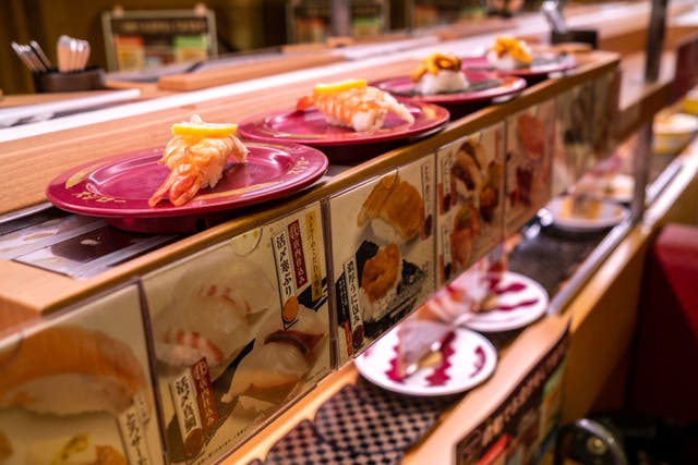 <p>Sushi seen on a conveyor belt at a sushi chain restaurant in Tokyo </p>