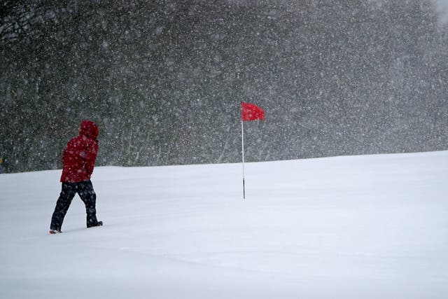 Snow falls at the Saddleworth Moor golf course near Oldham (Peter Byrne/PA)