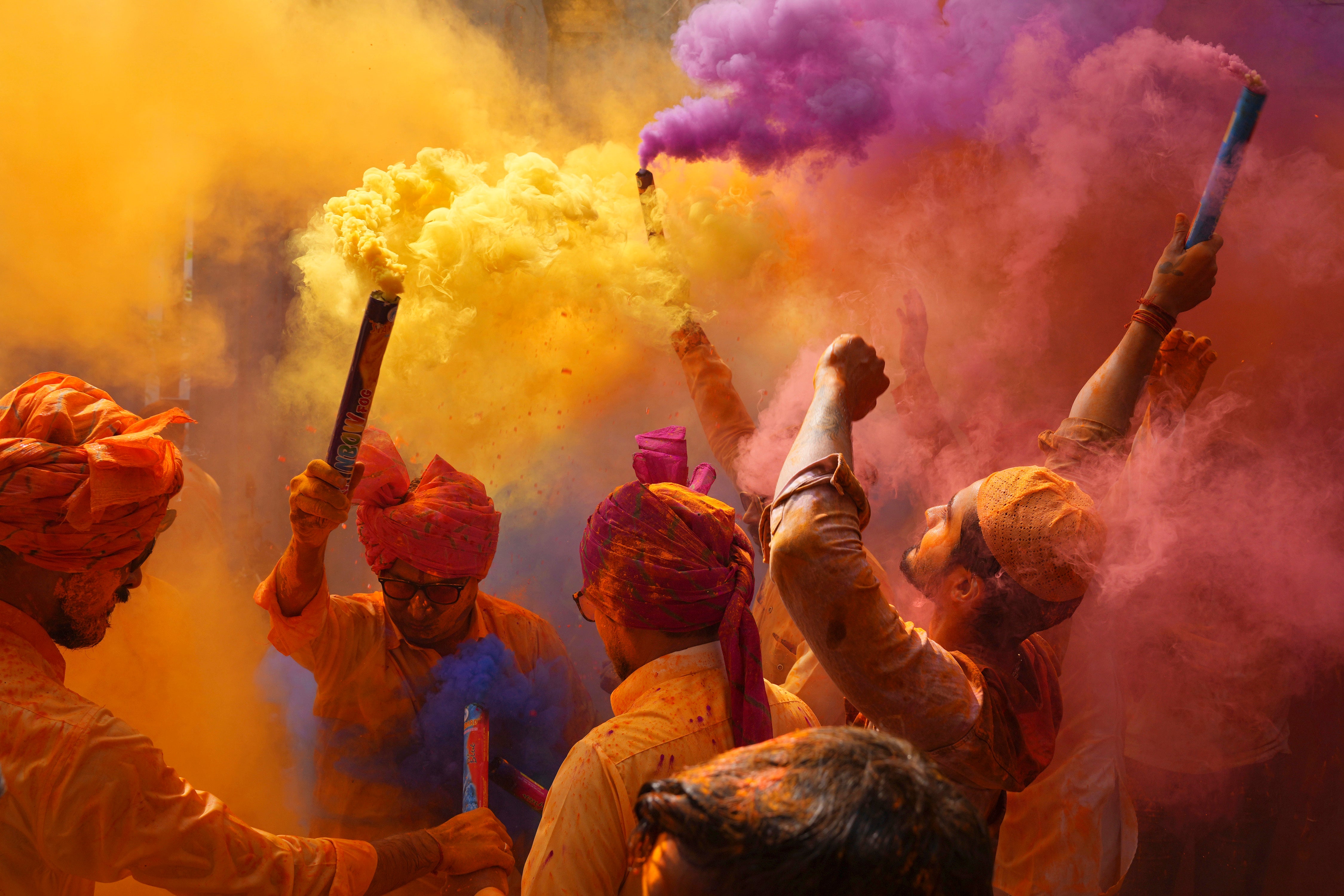 People sing, dance and throw colors at each other to celebrate Holi festival in Hyderabad, India
